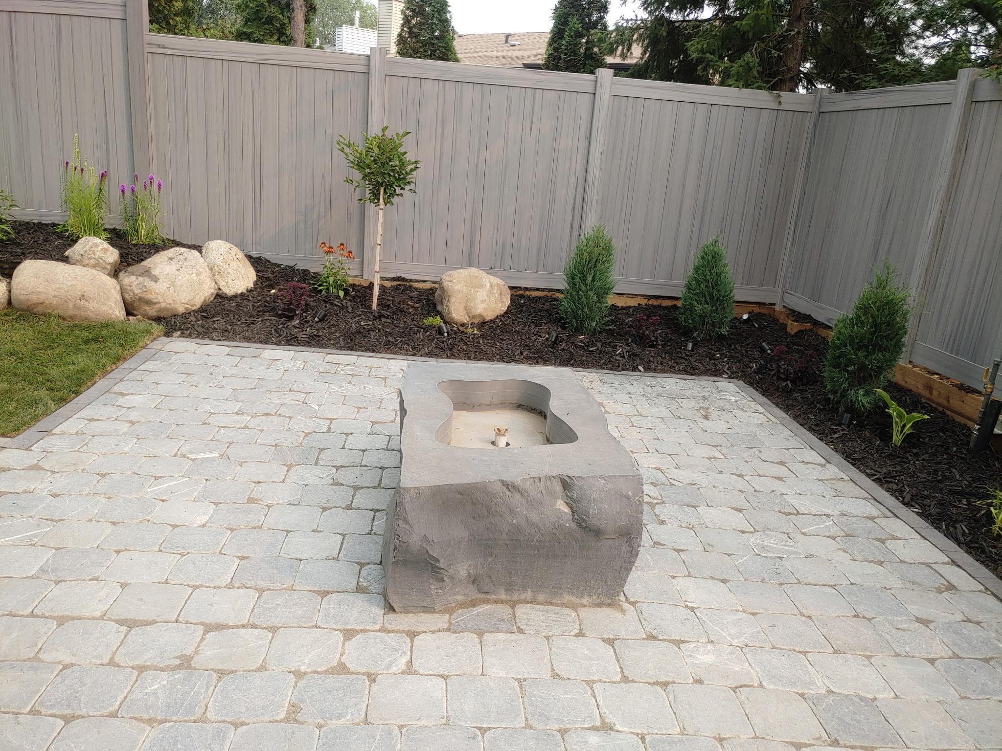 ALA Landscaping completed paver patio with stone fire pit feature